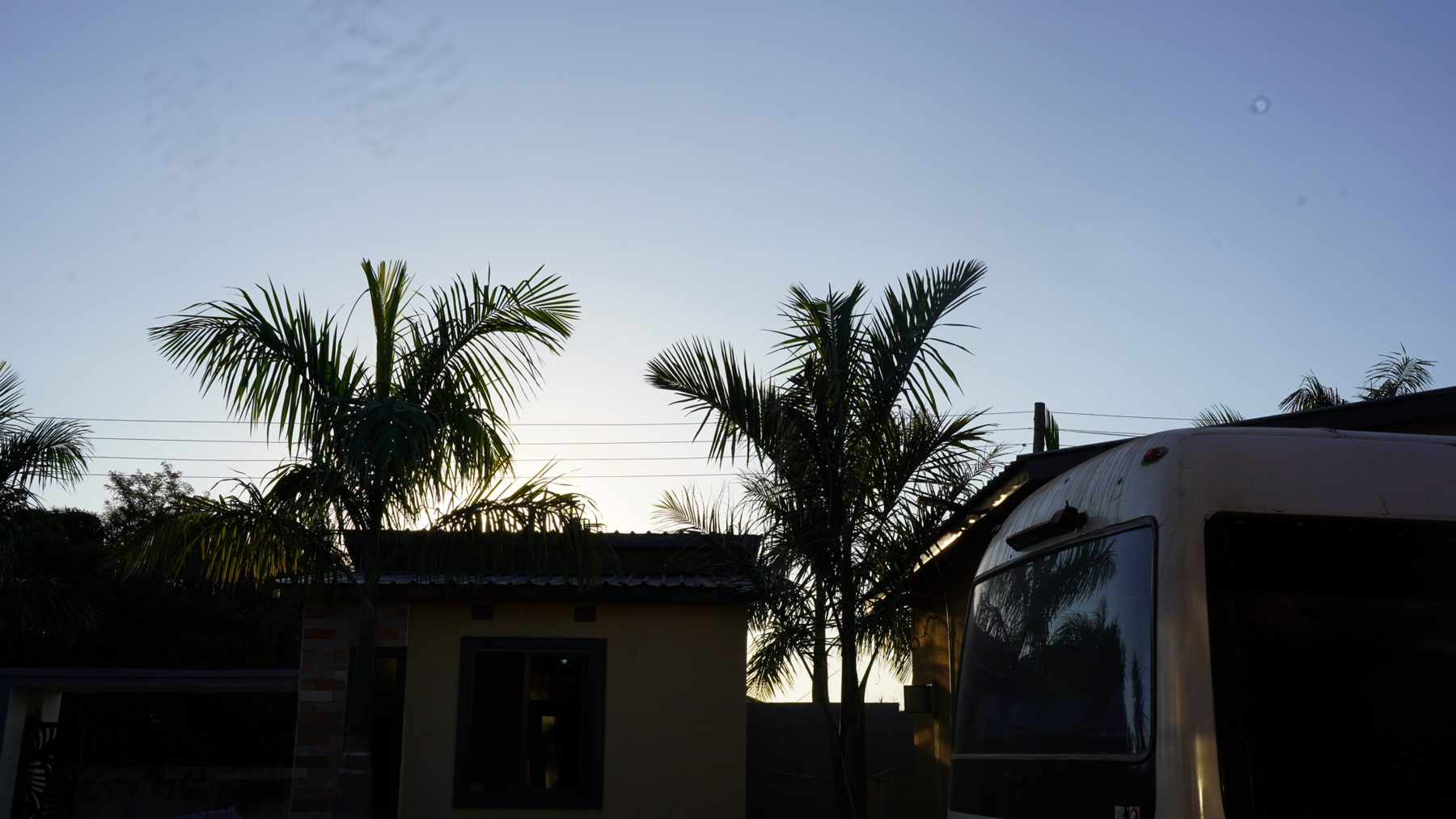 The tour bus parked at sunset on arrival in Lusaka