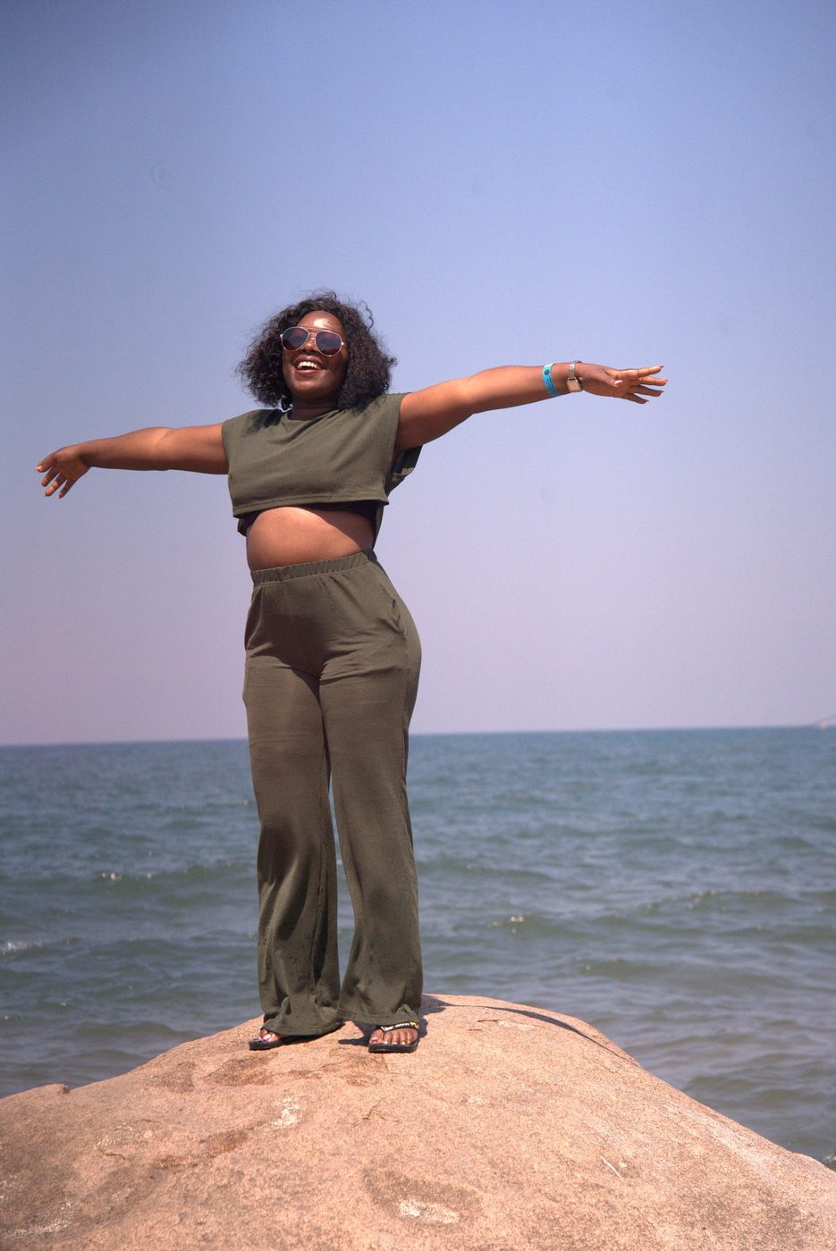 Arms out on a rock at Lake Malawi