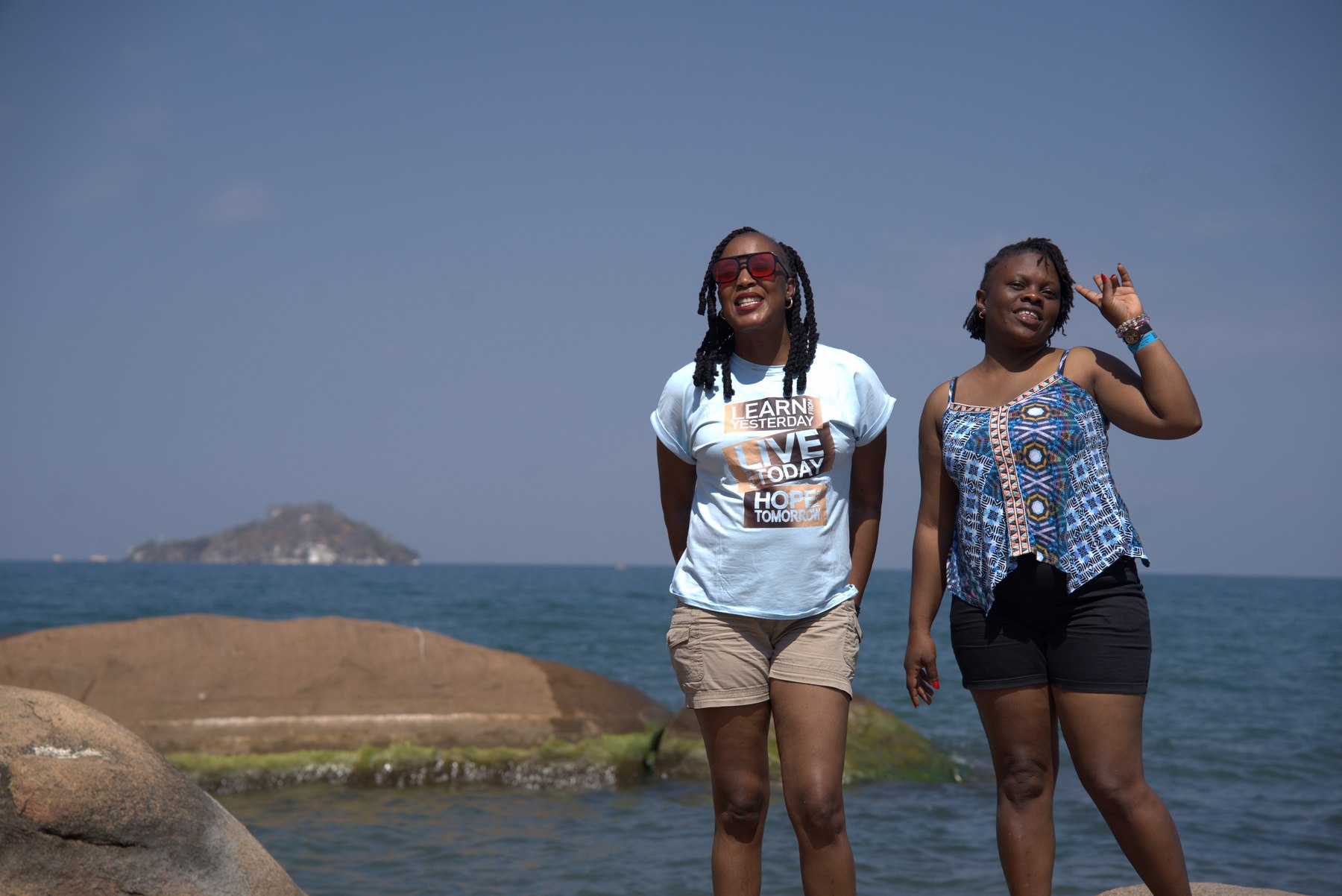 Friends at the water's edge on the Lake Malawi border hop